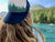 girl looking at mountains with trucker hat on backwards