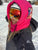 Girl wearing fuzzy hood over ski helmet with space kitty design